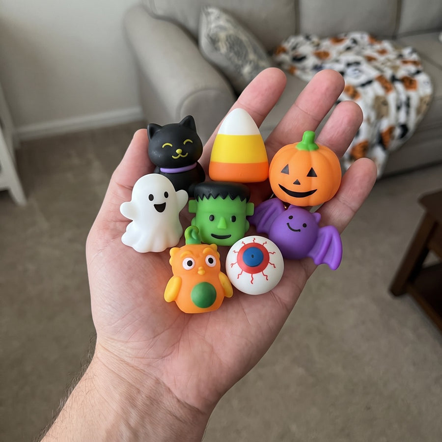 A handful of Halloween squishies held in an open palm
