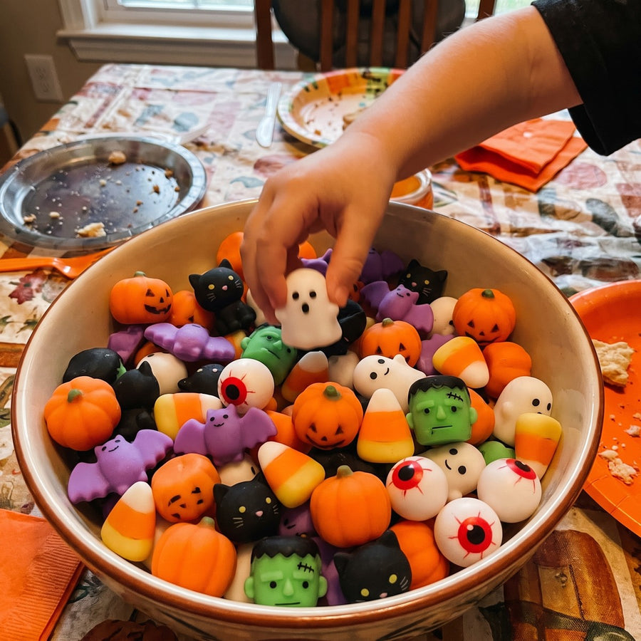 A child picking a squishy out of a bowl